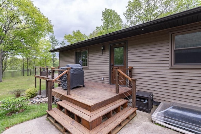 deck featuring a grill and a yard