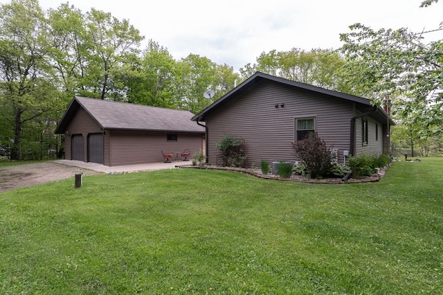 view of side of property with a yard and a garage