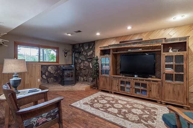 living room with wooden walls and dark hardwood / wood-style flooring