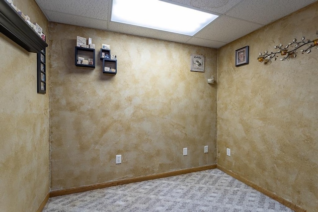 interior space with carpet flooring and a drop ceiling