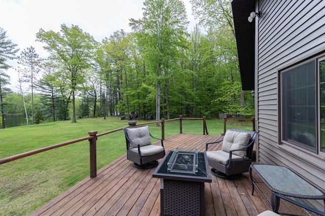 deck featuring a yard and a fire pit