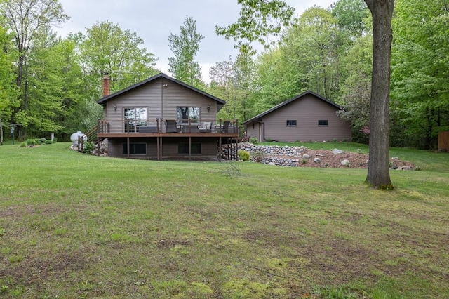 back of property featuring a lawn and a deck