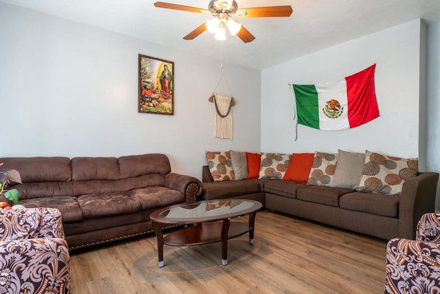 living room featuring ceiling fan and hardwood / wood-style floors