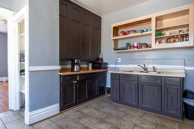 kitchen featuring tile floors and sink