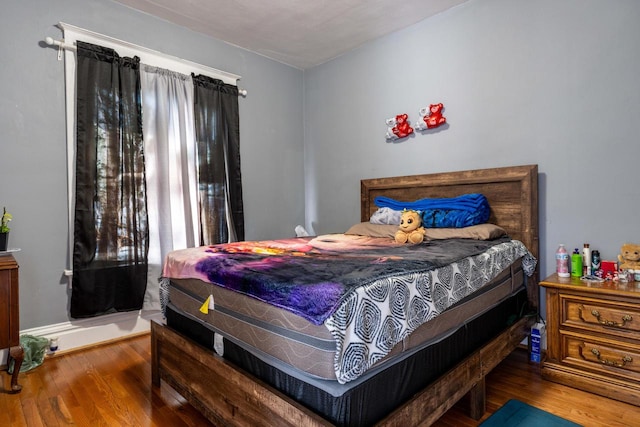 bedroom with hardwood / wood-style flooring