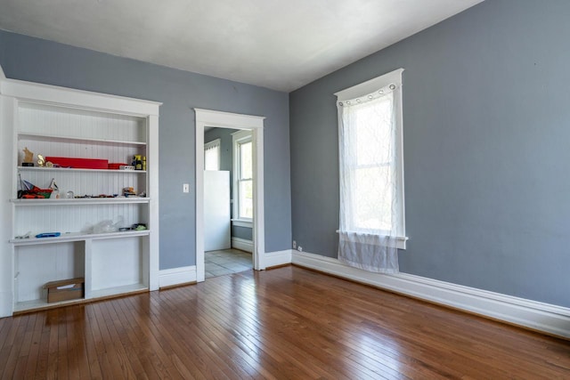 unfurnished bedroom with hardwood / wood-style floors