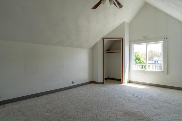 additional living space featuring carpet, ceiling fan, and vaulted ceiling