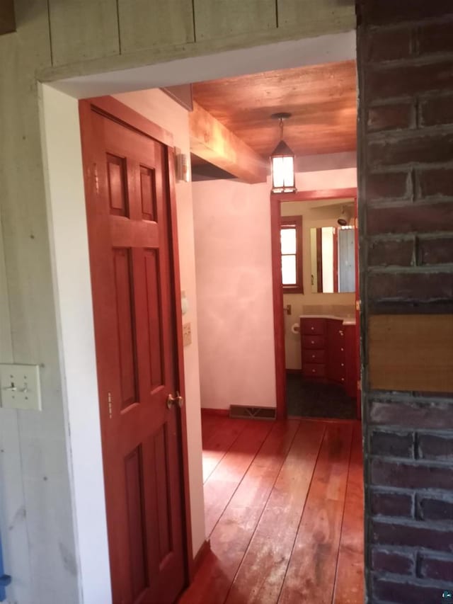 corridor featuring dark wood-type flooring and wood ceiling