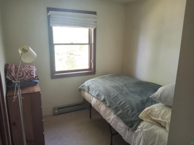 carpeted bedroom featuring baseboard heating