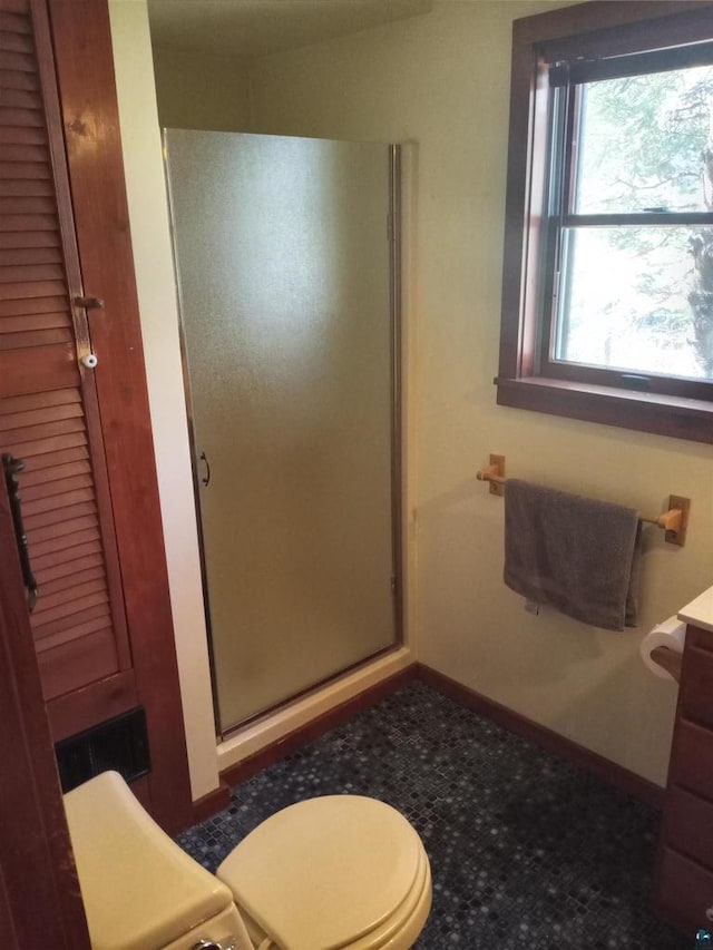 bathroom featuring walk in shower, vanity, and toilet