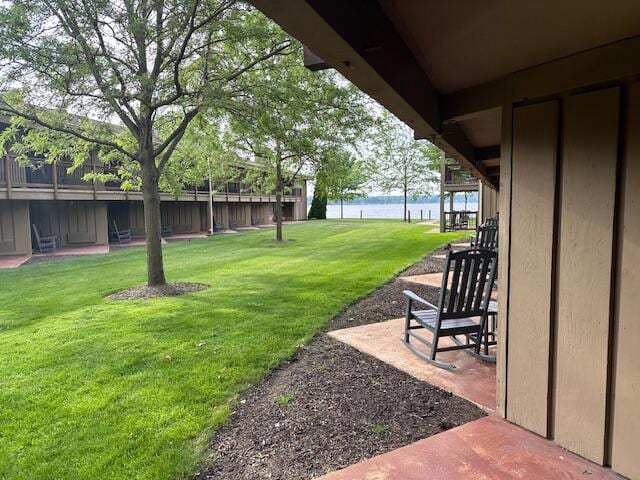 view of yard with a patio area and a water view