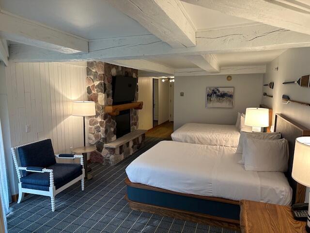 carpeted bedroom featuring beam ceiling