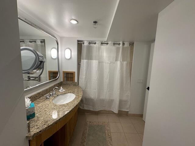 bathroom with tile floors and large vanity