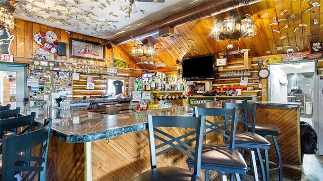 14549 Plummer Rd, Weyerhaeuser, WI 54895 - bar with vaulted ceiling and an inviting chandelier