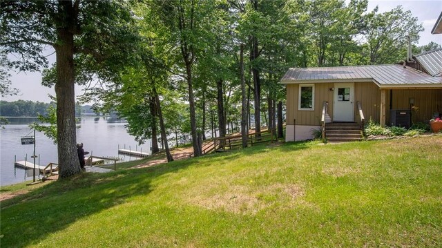 14549 Plummer Rd, Weyerhaeuser, WI 54895 - view of yard featuring central air condition unit, a water view, and a dock