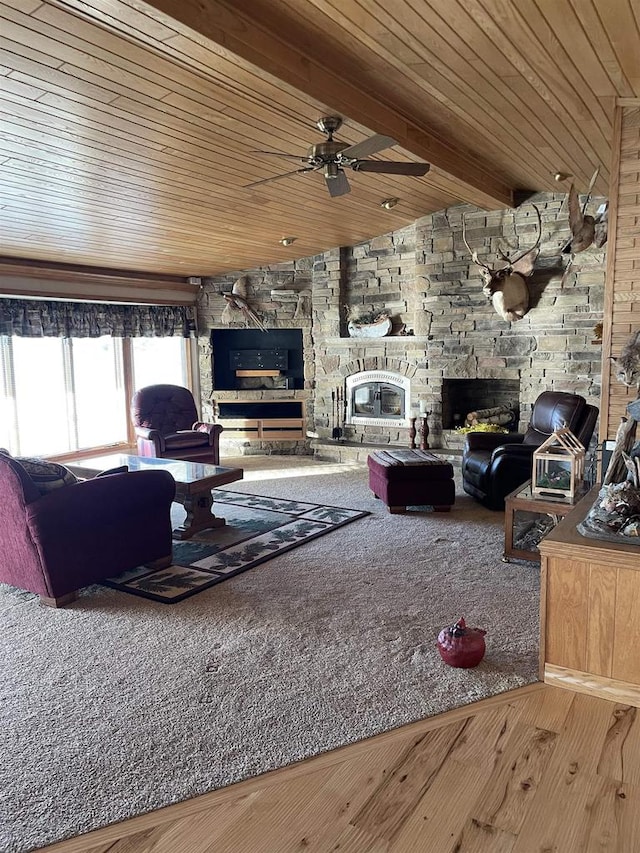 living room featuring hardwood / wood-style floors, ceiling fan, wood walls, and a stone fireplace