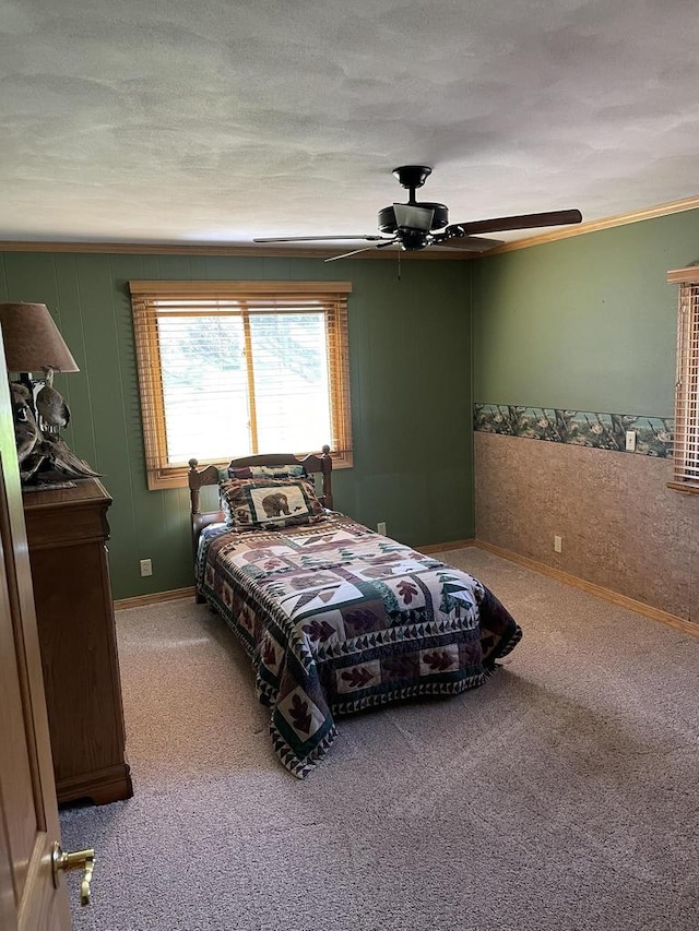 bedroom featuring carpet, ceiling fan, crown molding, and a textured ceiling