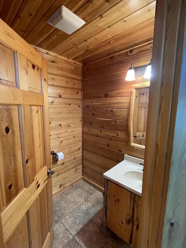 bathroom featuring tile patterned flooring, vanity, wood ceiling, and wooden walls