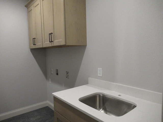 clothes washing area featuring washer hookup, sink, and cabinets