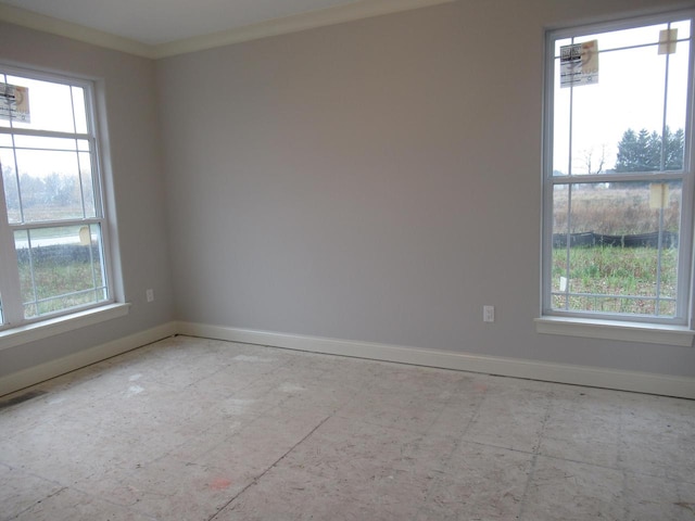 unfurnished room featuring crown molding