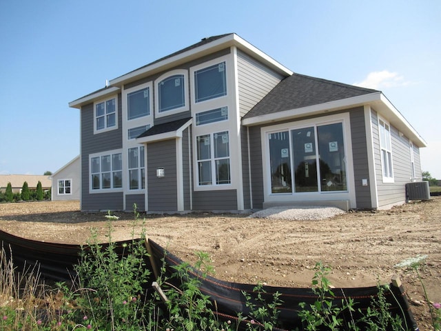 rear view of property with central AC unit