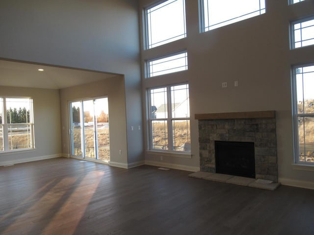 unfurnished living room featuring dark wood-type flooring and a fireplace