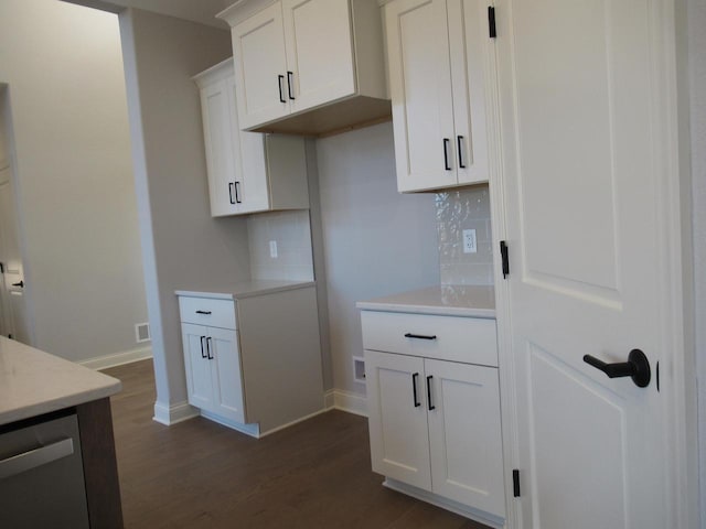 kitchen featuring white cabinetry, decorative backsplash, dark wood-type flooring, and dishwasher