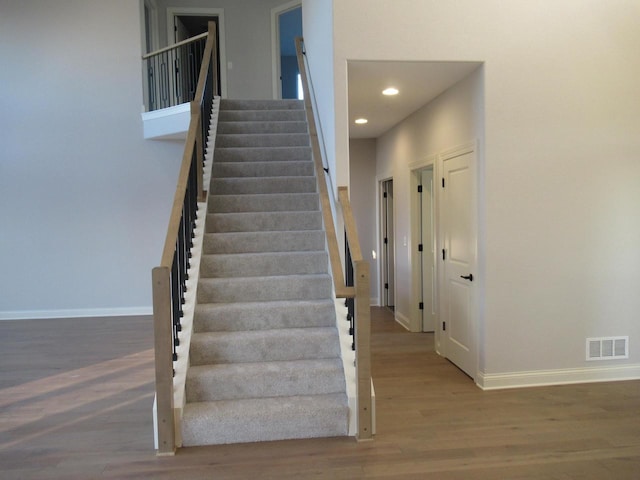 stairway featuring hardwood / wood-style flooring