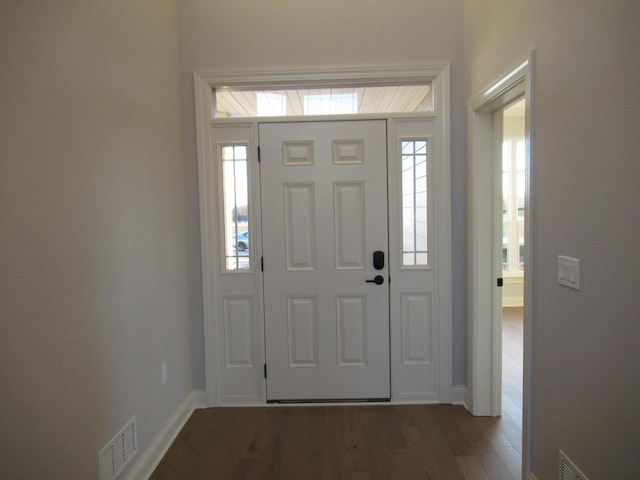 foyer entrance with dark hardwood / wood-style floors