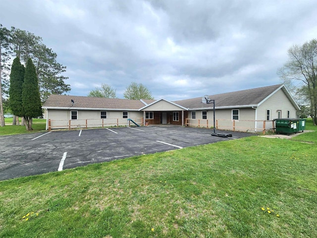 exterior space with a front lawn and basketball court