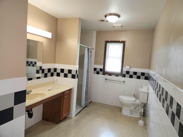 bathroom featuring a shower with curtain, toilet, tile walls, and sink