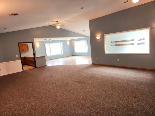 empty room featuring ceiling fan, lofted ceiling, and carpet floors