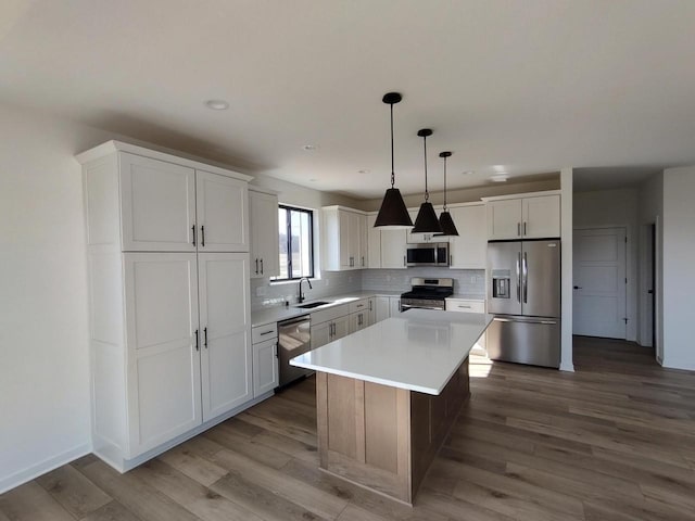 485 Chapman Farm Blvd, Mukwonago, WI 53149 - kitchen featuring appliances with stainless steel finishes, a sink, white cabinetry, decorative backsplash, and recessed lighting