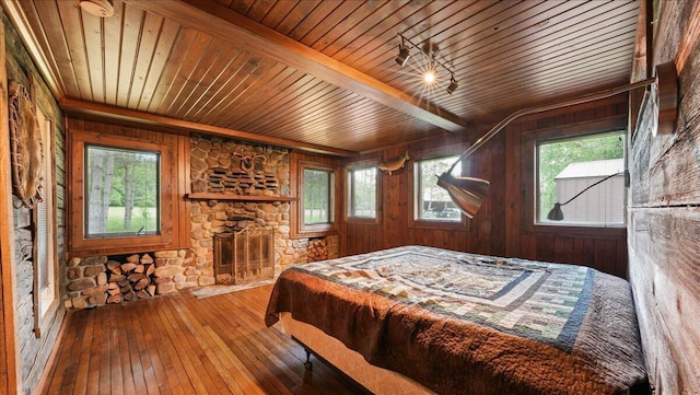 bedroom with wood-type flooring, multiple windows, and wood ceiling