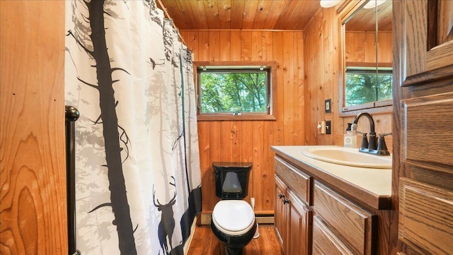 bathroom featuring plenty of natural light, toilet, wood ceiling, and wooden walls