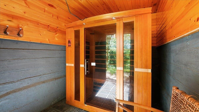 doorway featuring wood walls and wooden ceiling