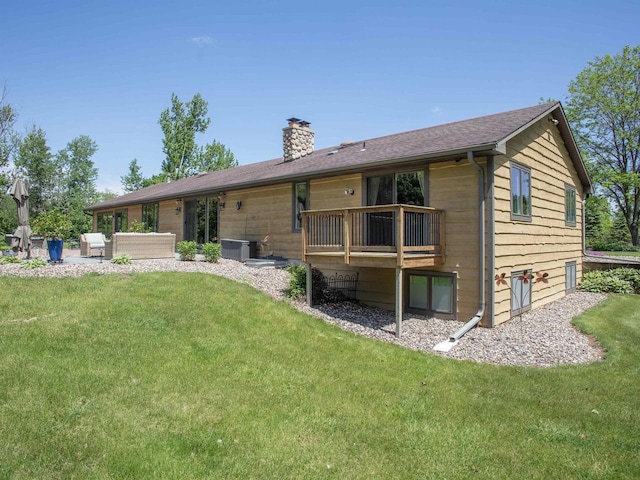 back of property with outdoor lounge area, a yard, and a patio