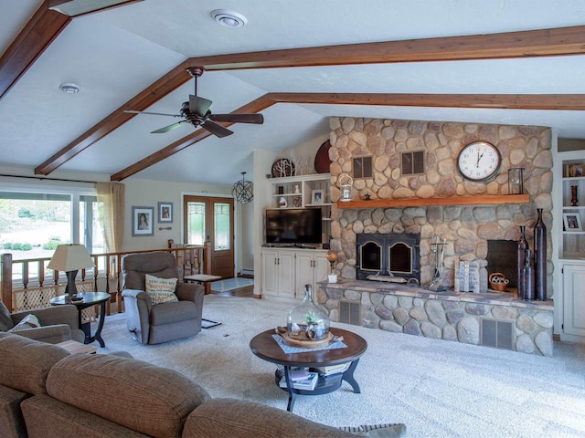 living room featuring a stone fireplace, light carpet, ceiling fan, and vaulted ceiling with beams