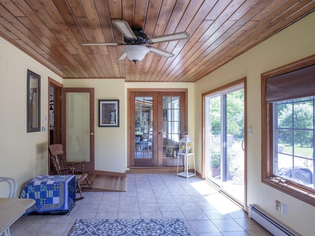 interior space featuring baseboard heating, ceiling fan, french doors, and wood ceiling