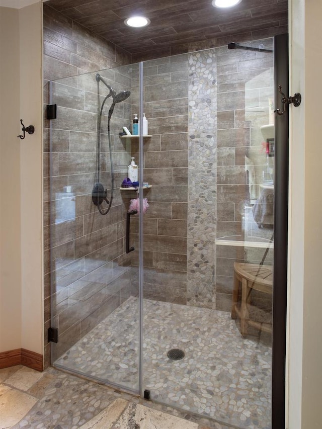 bathroom featuring a shower with door