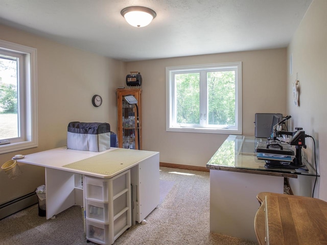 carpeted office space featuring a wealth of natural light and a baseboard heating unit