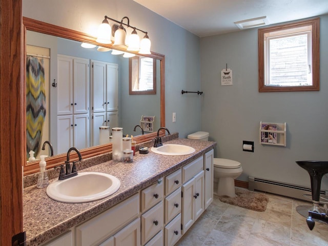 bathroom featuring vanity, toilet, and a baseboard heating unit