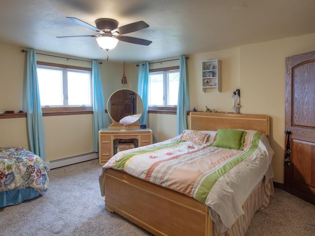 bedroom featuring ceiling fan, light carpet, and a baseboard heating unit