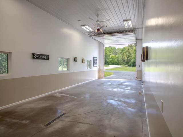 garage featuring ceiling fan, wooden ceiling, and a garage door opener