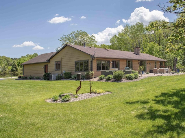 back of house with a yard and a patio