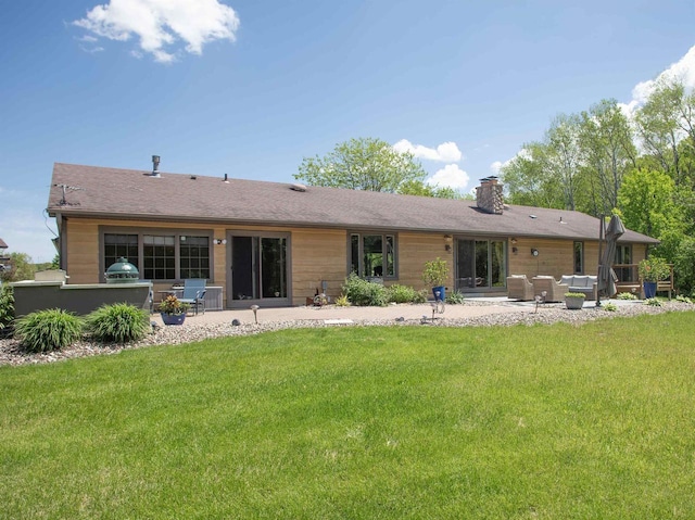 rear view of property featuring a lawn, a patio area, and outdoor lounge area