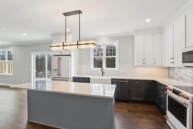 kitchen with tasteful backsplash, white appliances, a sink, and light stone countertops