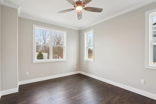 empty room featuring ornamental molding, dark wood-style flooring, baseboards, and a ceiling fan