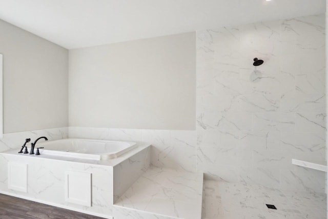 full bathroom with a marble finish shower and a bath