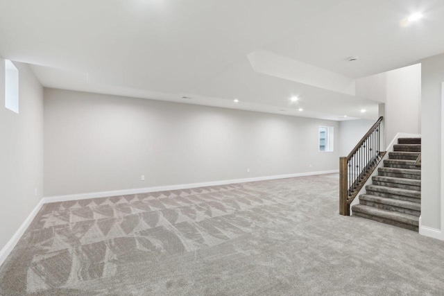 below grade area featuring recessed lighting, carpet, stairway, and baseboards